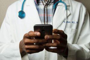 Healthcare development must haves - doctor using mobile device