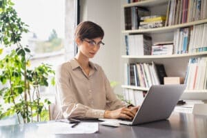 woman using SEO automation tools on laptop